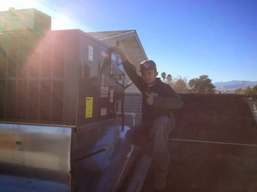 HVAC technician performing HVAC Inspection on a rooftop unit in Macon-Bibb County